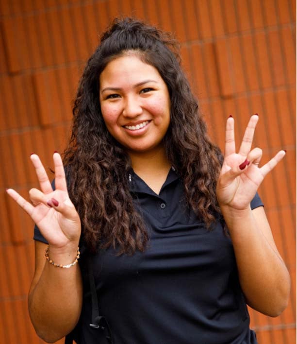 student making the pitchfork sign